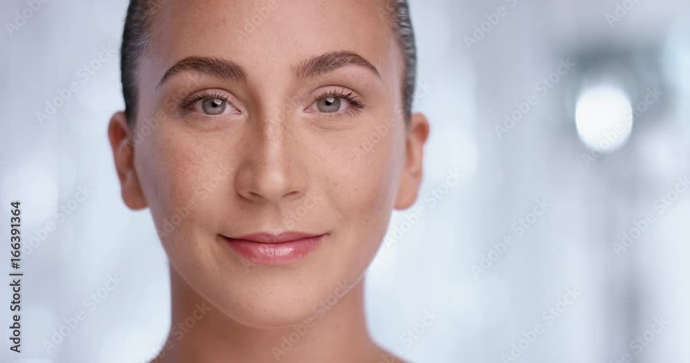 Beautiful young woman turning her head to camera and starting to smile Beautiful young woman turning her head to camera and starting to smile