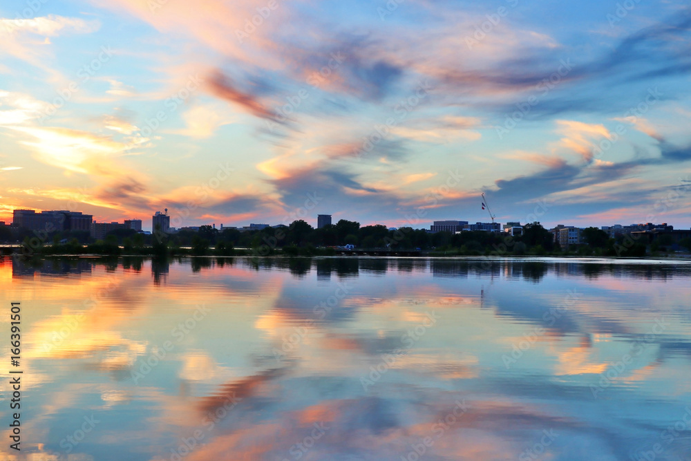 Beautiful colored after sunset sky reflects in water. Summer landscape with sunset over Madison, Wisconsin, USA.