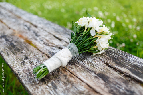 Beautiful summer wedding bouquet on old gray wooden background. With place for text. photo