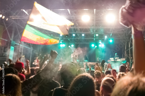 Reggae concert with jamaican flags and cheering crowd photo