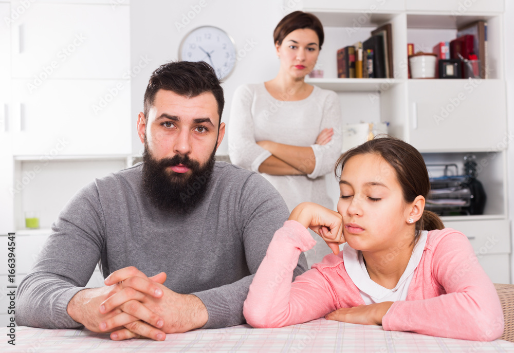 Fototapeta premium Mother lecturing husband and daughter
