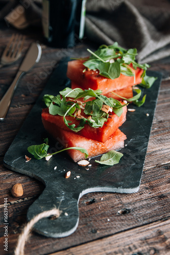 Watermelon salad with arugula, almonds and balsamic vinegar photo