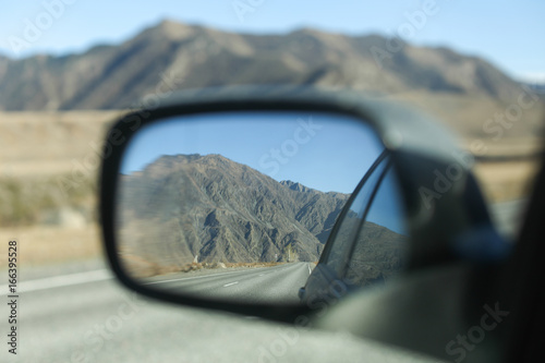 Mountain in a car mirror