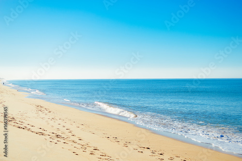 View of beautiful beach on sunny day idyllic natural outdoors background. Joy and peace seascape sunshine environment