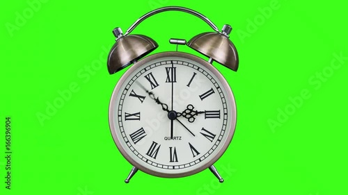 Antique alarm clock with minute and hour hands spinning a full 12 hour loop on green screen
