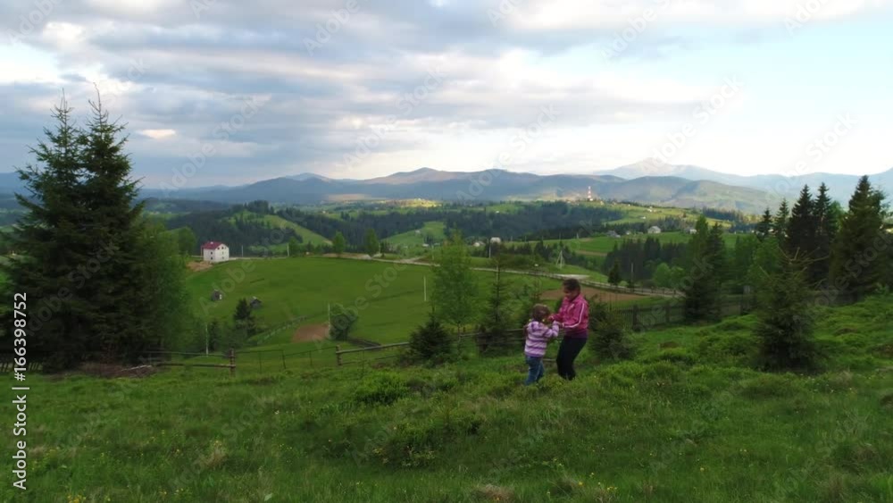 Aerial shot, family walking along, spring day in forest Aerial shot, family walking along, spring day in forest