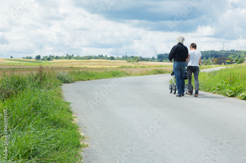 Grandparents Going For A Walk With Granchild