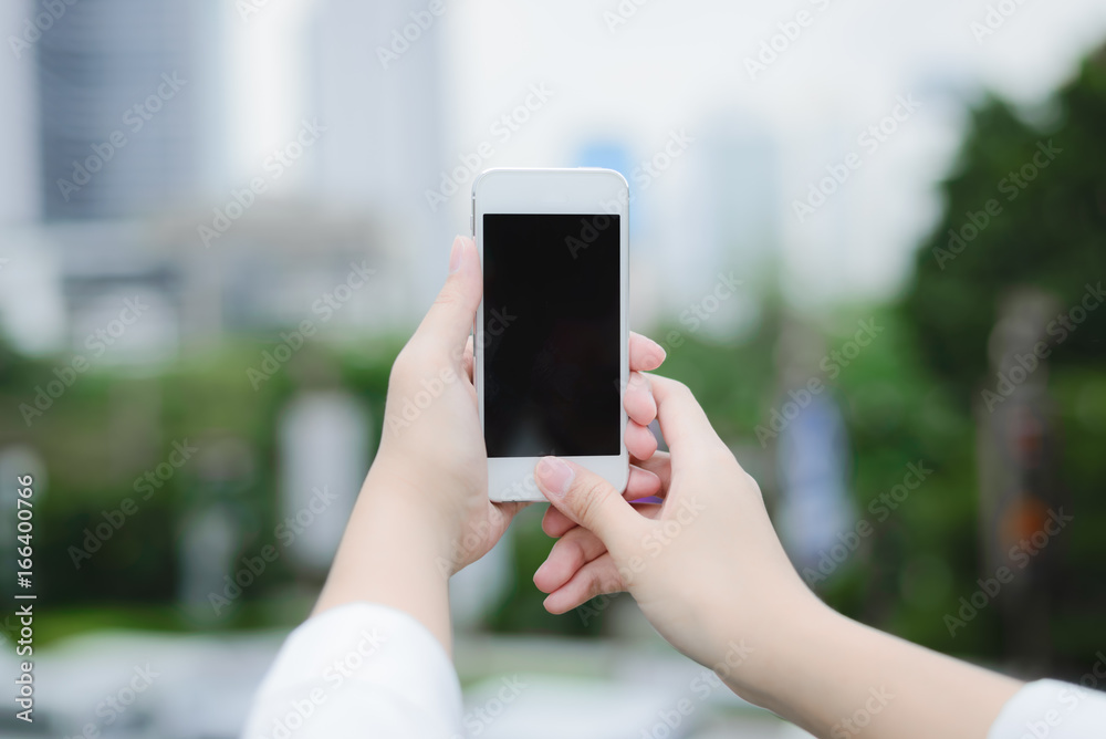 young woman use smart phone in modern city