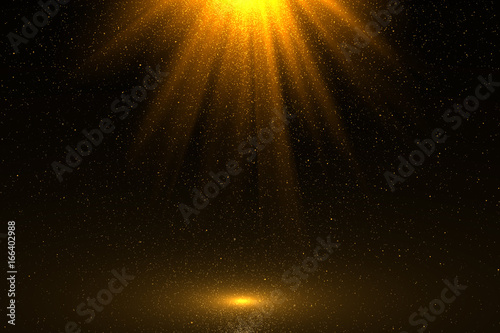 Golden sunray with sparkles or gold particle glitter light. Merry Christmas festive background.defocused circle particle bokeh. Abstract gold background