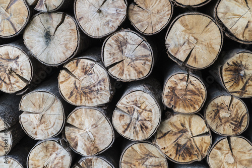 Natural wooden background.closeup of chopped firewood.visible stacked firewood