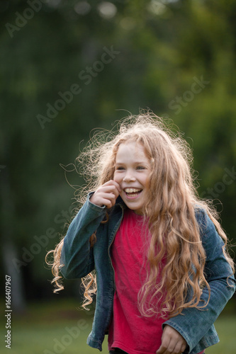 Pretty smiling child posing in park