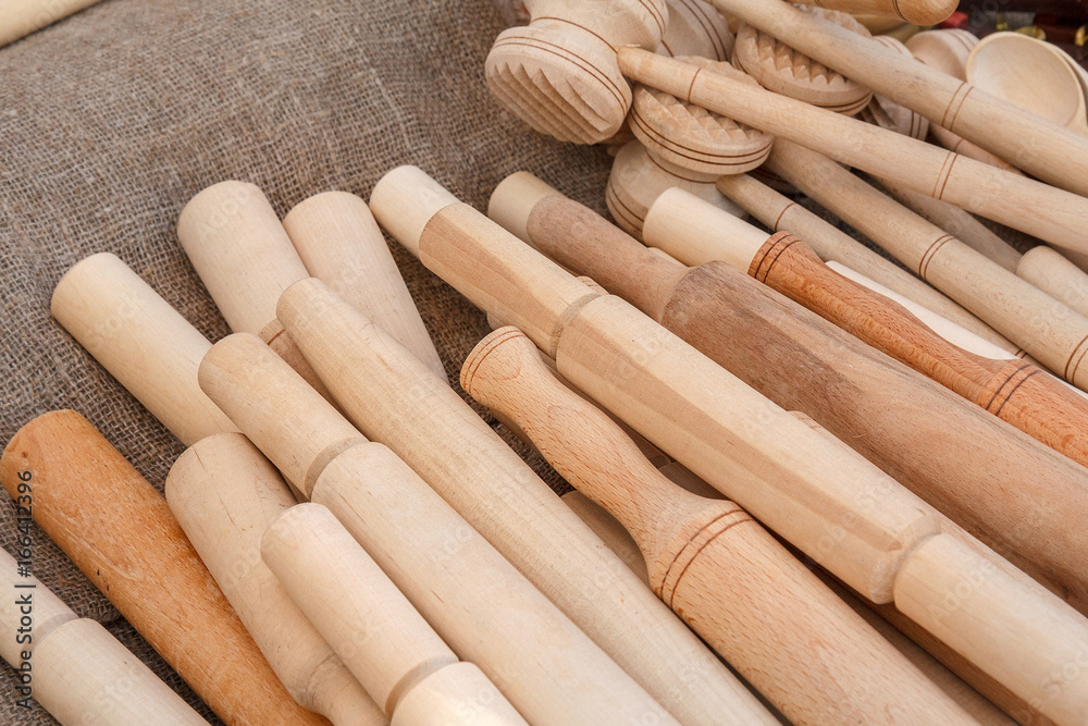 Various rolling-pin and a hammer for pounding meat from wood. Wooden household items are presented at the fair. Traditional Belarusian crafts. Various rolling-pin and a hammer for pounding meat from wood. Wooden household items are presented at the fair. Traditional Belarusian crafts.