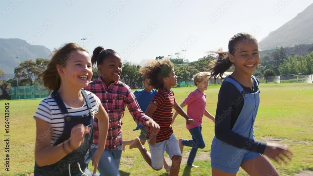Six friends running in a park, tracking shot, close up