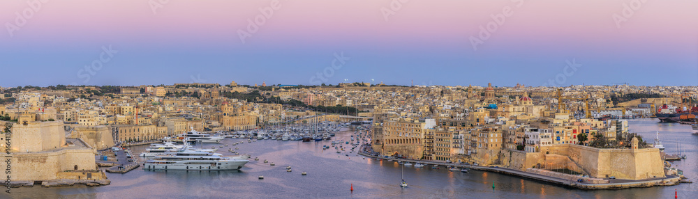 View to Grand Harbor from Upper Barrakka Gardens in Valletta at sunset, Malta