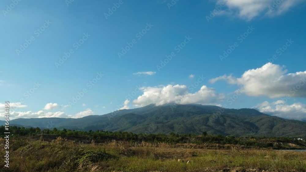 Beautiful scene of fluffy clouds moving behind the mountain - Timelapse , 4k Beautiful scene of fluffy clouds moving behind the mountain - Timelapse , 4k