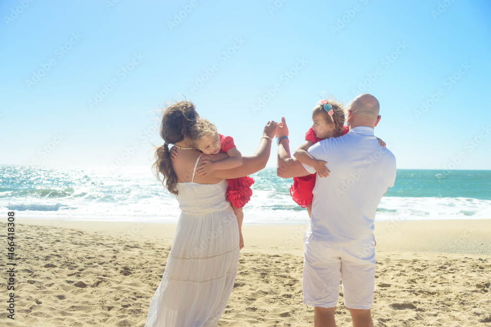 Happy family holding hands on the beach Happy family holding hands on the beach
