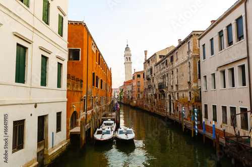 Boats in canal ,Venice (Italy). Dangling boat reflection in canal water. photo