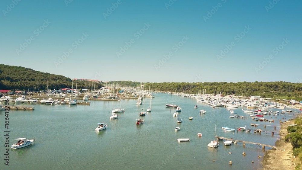 Aerial shot of anchored boats, motorboats and yachts at the Adriatic sea marina