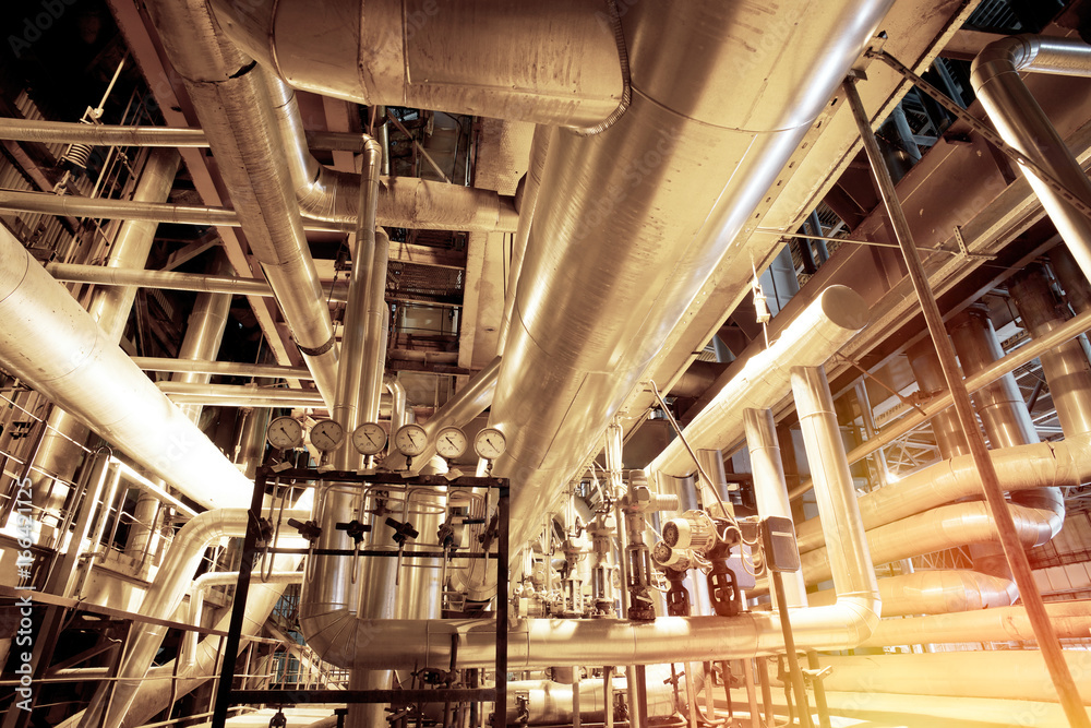 Equipment, cables and piping as found inside of a modern industrial power plant Equipment, cables and piping as found inside of a modern industrial power plant