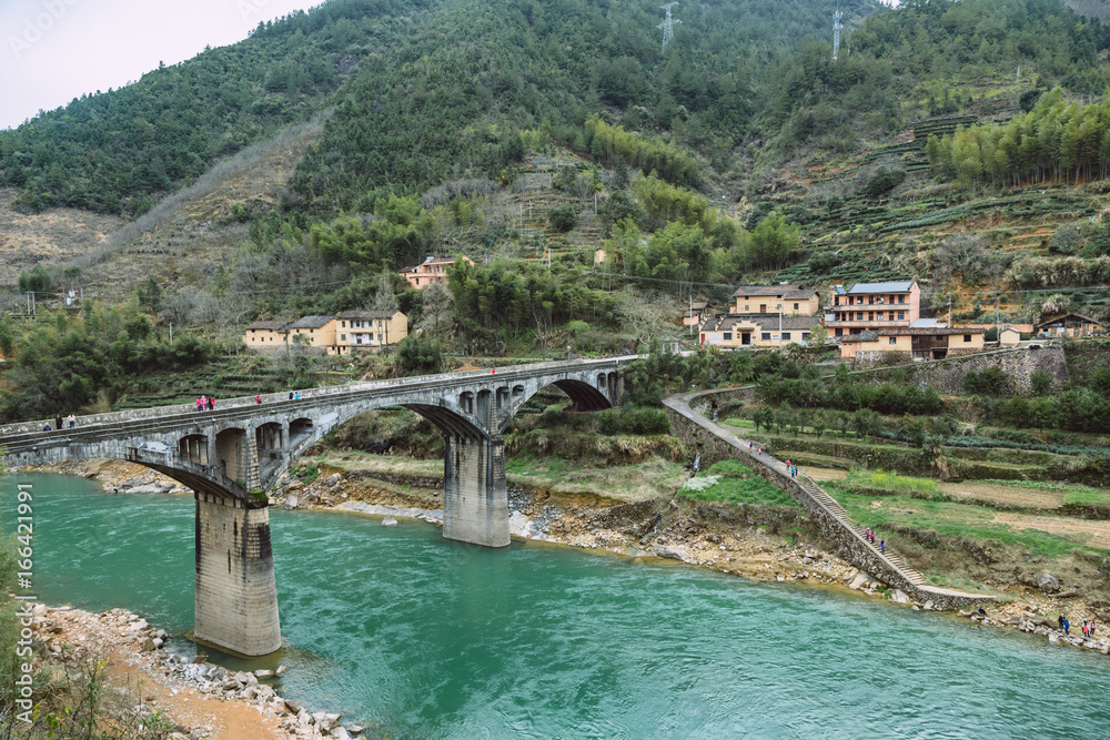 low angle view of old arch bridge over river. low angle view of old arch bridge over river.