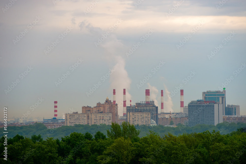 View of the district of the city of Moscow with high-rise buildings and pipes of a thermal power plant