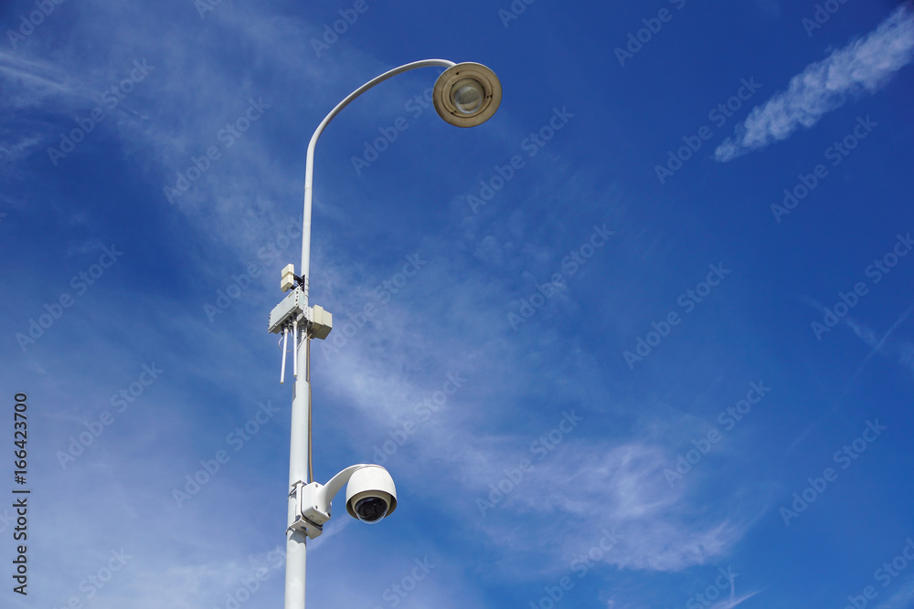 video surveillance on modern street lamp over blue sky video surveillance on modern street lamp over blue sky
