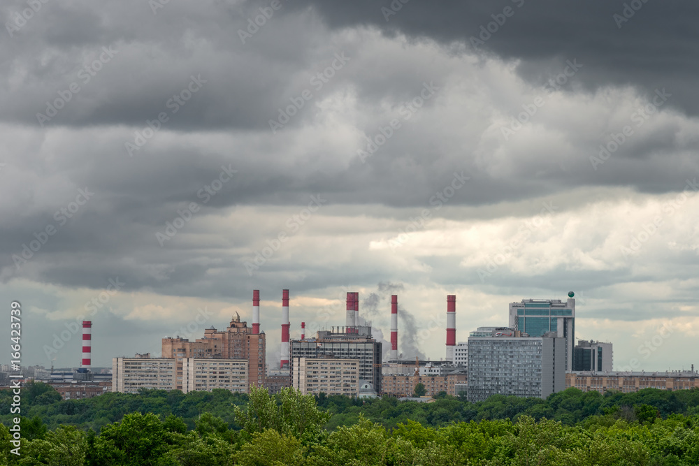  View of the district of the city of Moscow with high-rise buildings and pipes of a thermal power plant in bad weather