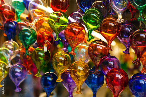 Valokuva Different colored glass bottles, vases, backlit with natural light