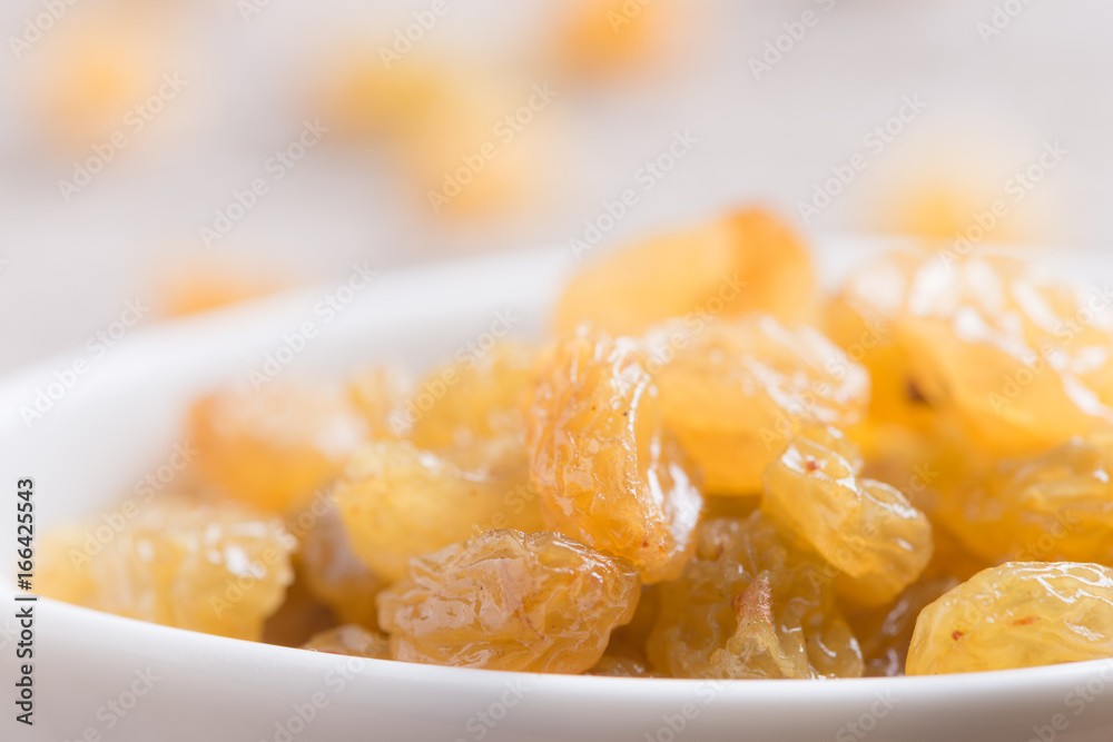 Dried yellow raisin fruits on  wood background
