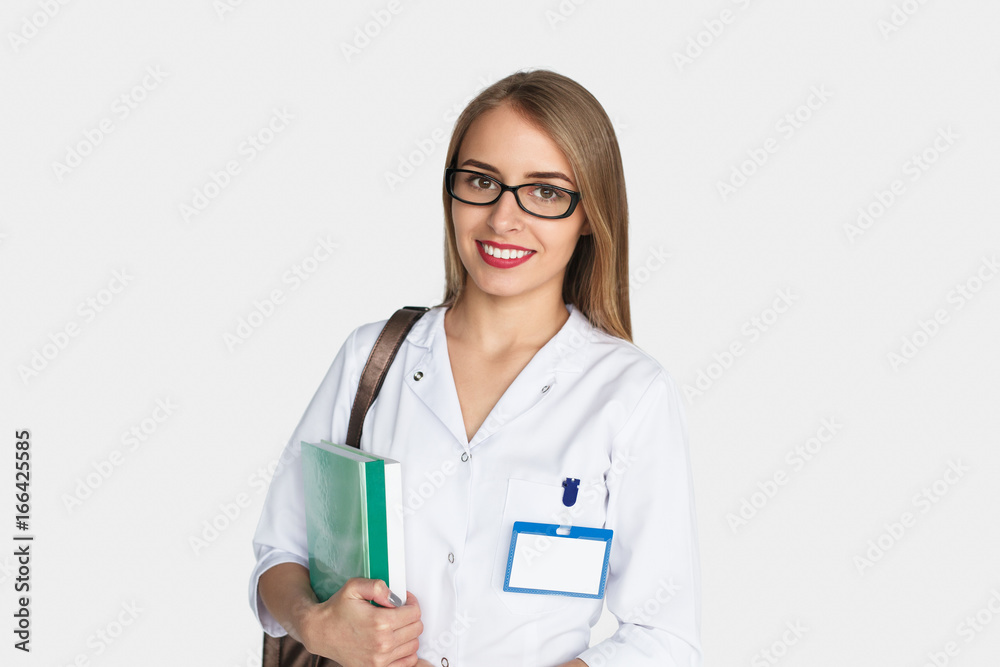 Young woman in white uniform holding cardboards Young woman in white uniform holding cardboards