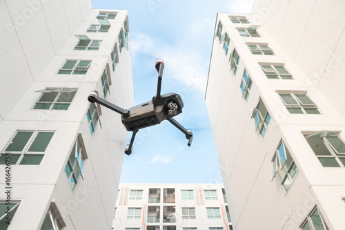 Drone flying over on building background.
