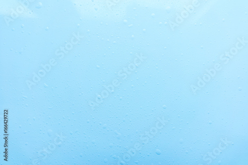 1222405 Drops, water splashes on blue background. Cute simple background, backdrop. Top view. Close-up. Stock photo