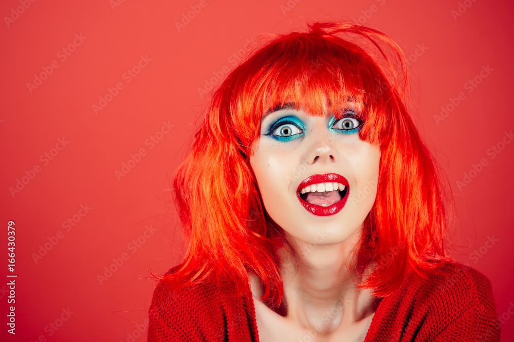 Woman in red wig with fashionable makeup.