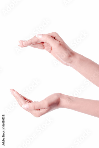 Female hands as if holding something.