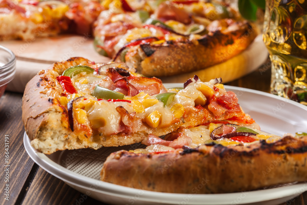 Slices of pizza with bacon, paprika and corn Slices of pizza with bacon, paprika and corn