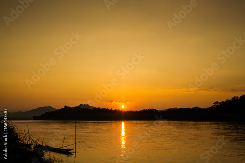 Tropical sunset above Mekong Laos © sitriel