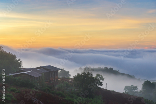 Small house in fog at sunrise