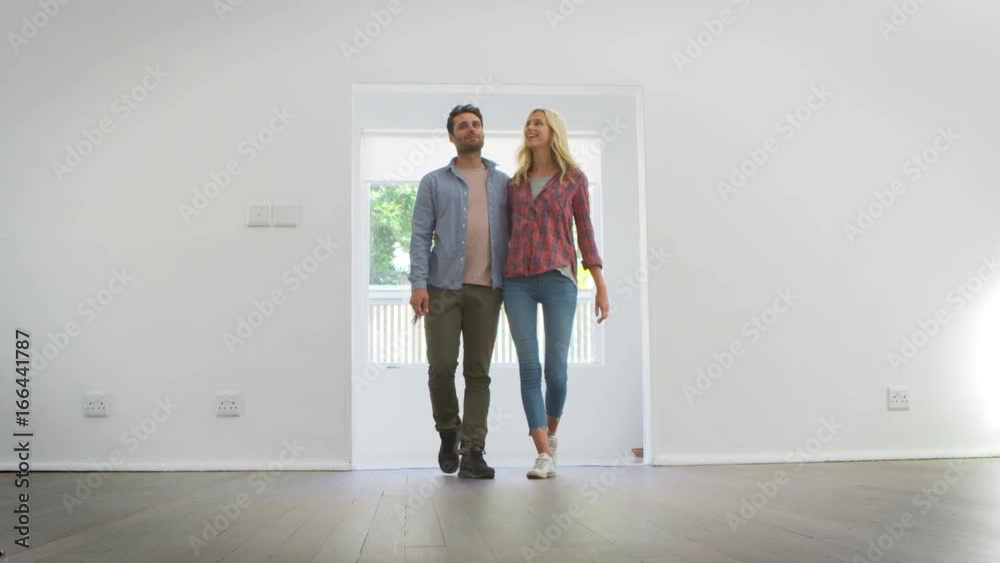 Excited Young Couple Moving Into New Home Together Excited Young Couple Moving Into New Home Together