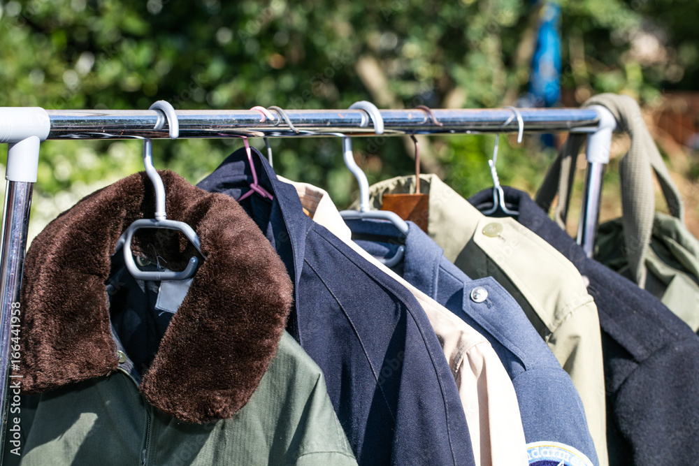 coats and jackets on rack at thrift store to resale Stock Photo | Adobe  Stock