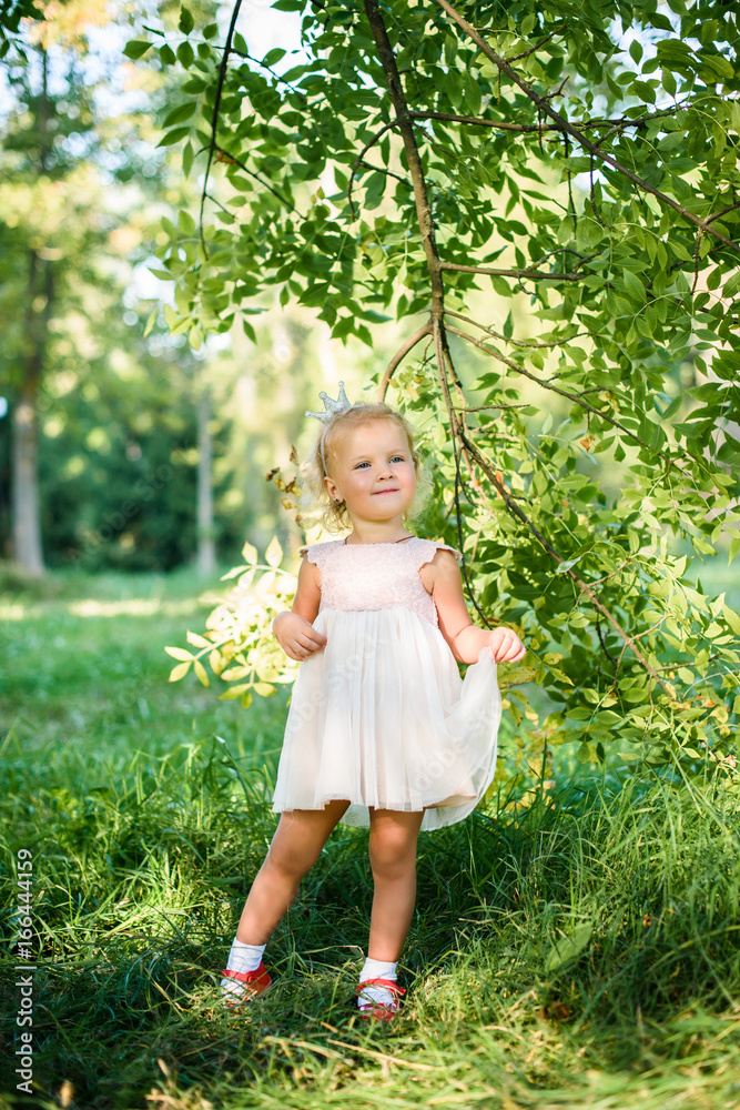 young beautiful girl walking in the park on a sunny summer day young beautiful girl walking in the park on a sunny summer day