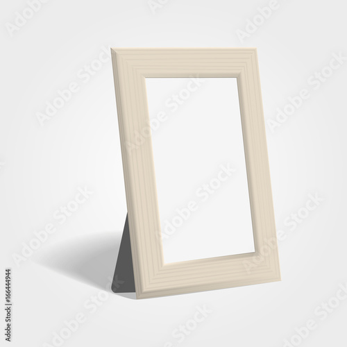 Realistic wooden picture or photo frame mock up standing on light background.