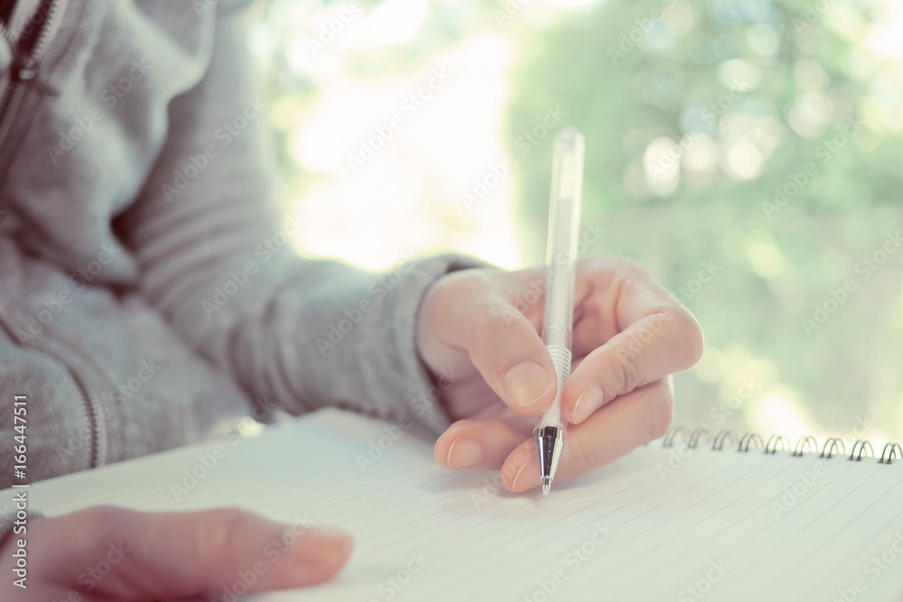 woman writing paper on left hand. business. write something on notebook woman writing paper on left hand. business. write something on notebook
