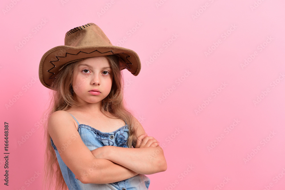 Kid with confident face and fair hair wears jeans dress Kid with confident face and fair hair wears jeans dress