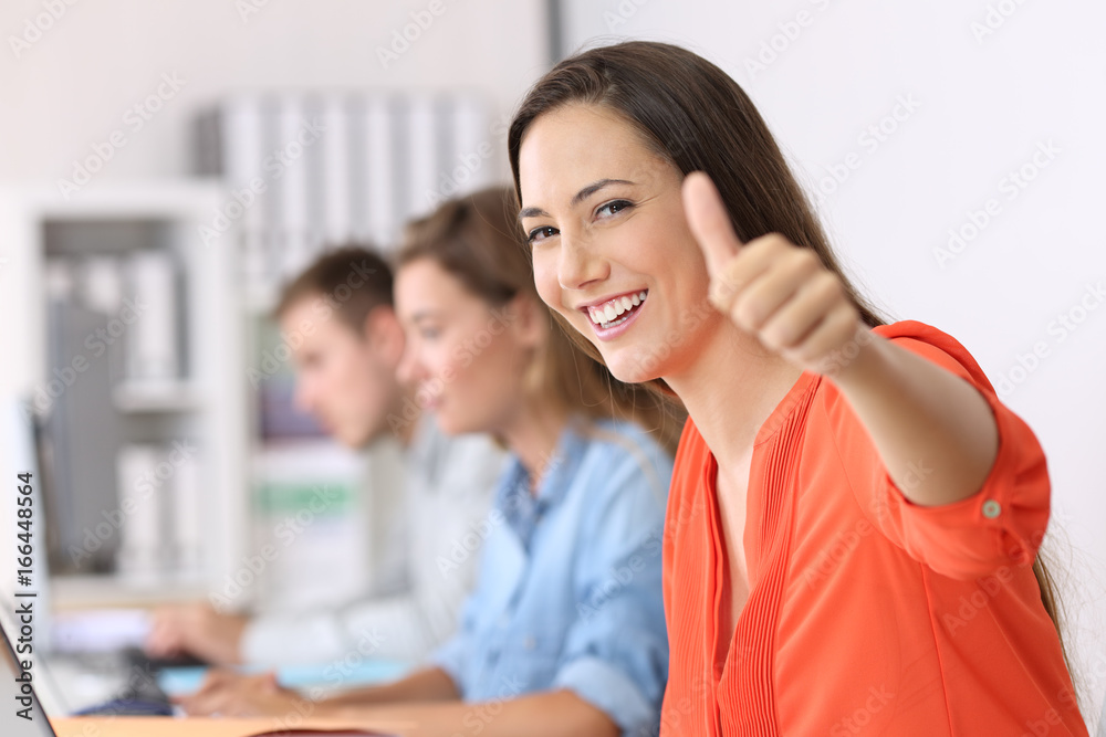 Happy employee looking at you with thumbs up Happy employee looking at you with thumbs up