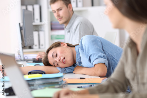 Fatigued employee sleeping at office photo