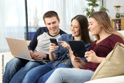 Happy friends sharing on line content at home