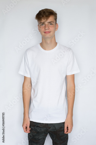 Smiling young man in white blank t-shirt isolated on white background, people and design concept © polya_olya