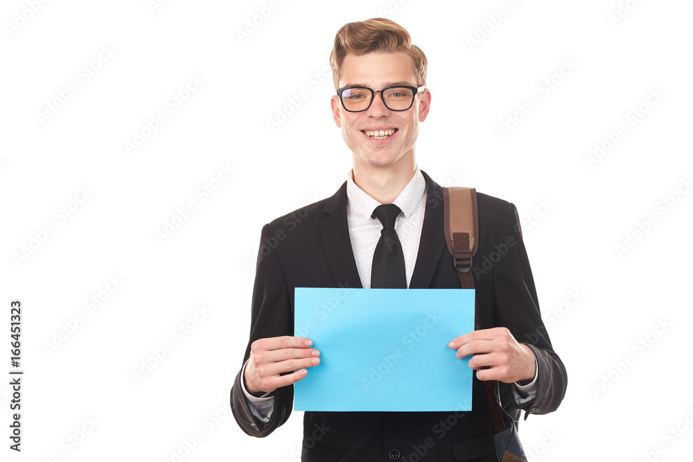Handsome college student posing in studio with blank paper sheet Handsome college student posing in studio with blank paper sheet