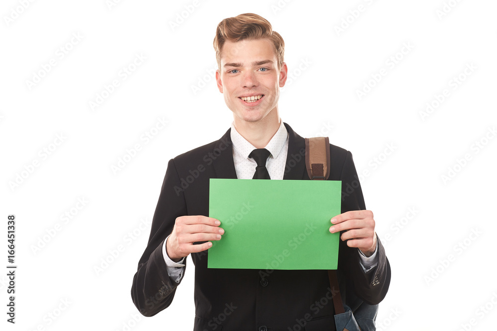 Handsome college student posing in studio with blank paper sheet Handsome college student posing in studio with blank paper sheet