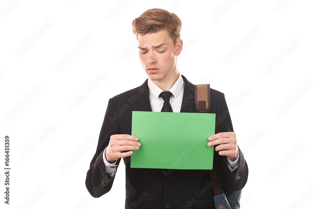 Handsome college student posing in studio with blank paper sheet Handsome college student posing in studio with blank paper sheet